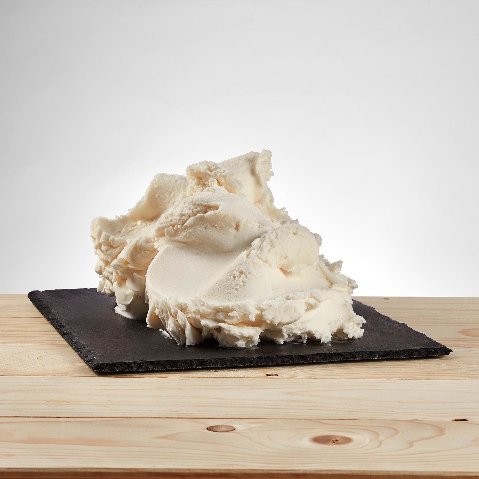 PreGel Base Allegra, creamy white dessert base from Papagino Foods Inc., in a large container with a smooth surface.