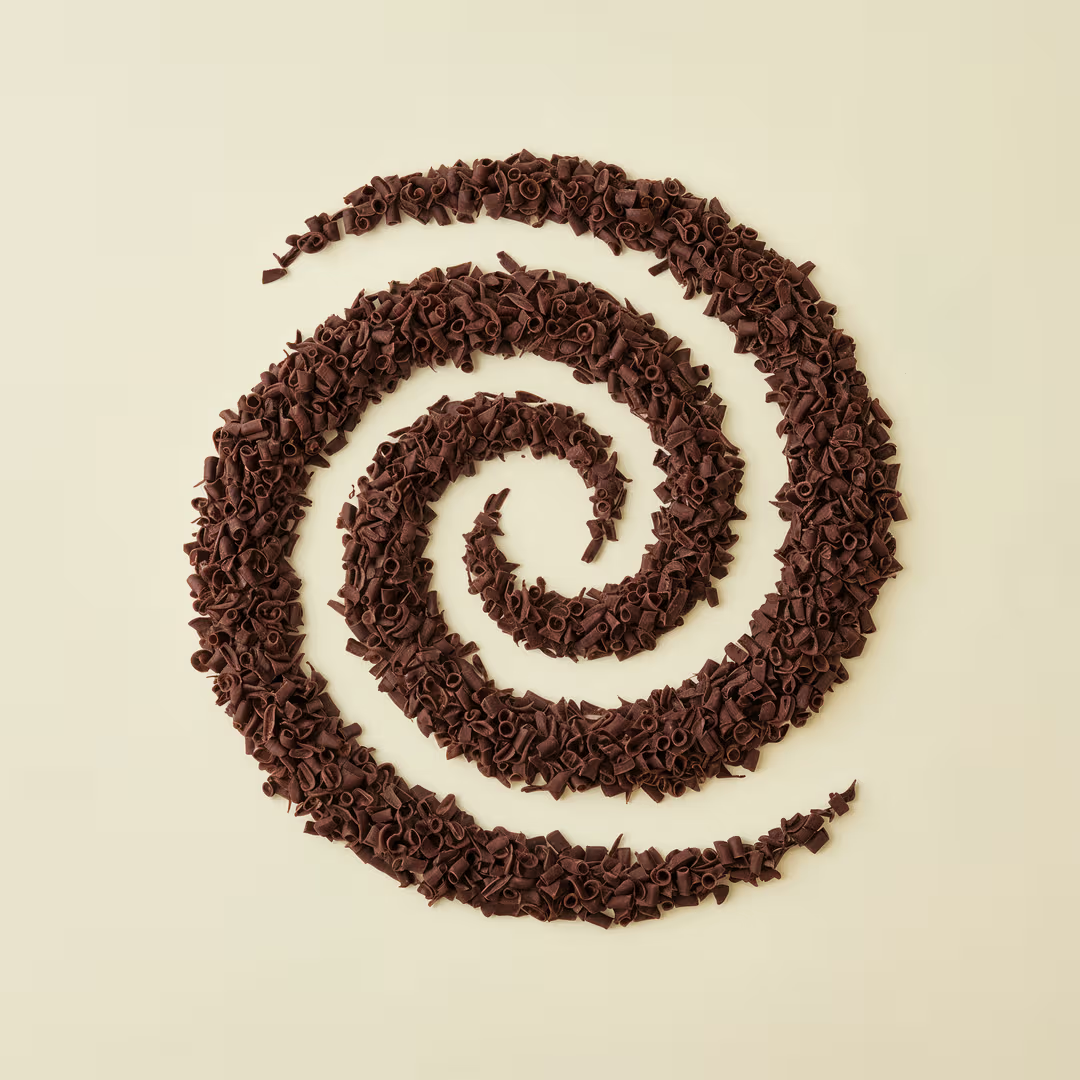 Barlo Dark Blossom Curls from Papagino Foods Inc. in 1kg pack, showing dark, curled blossom-shaped snack pieces.